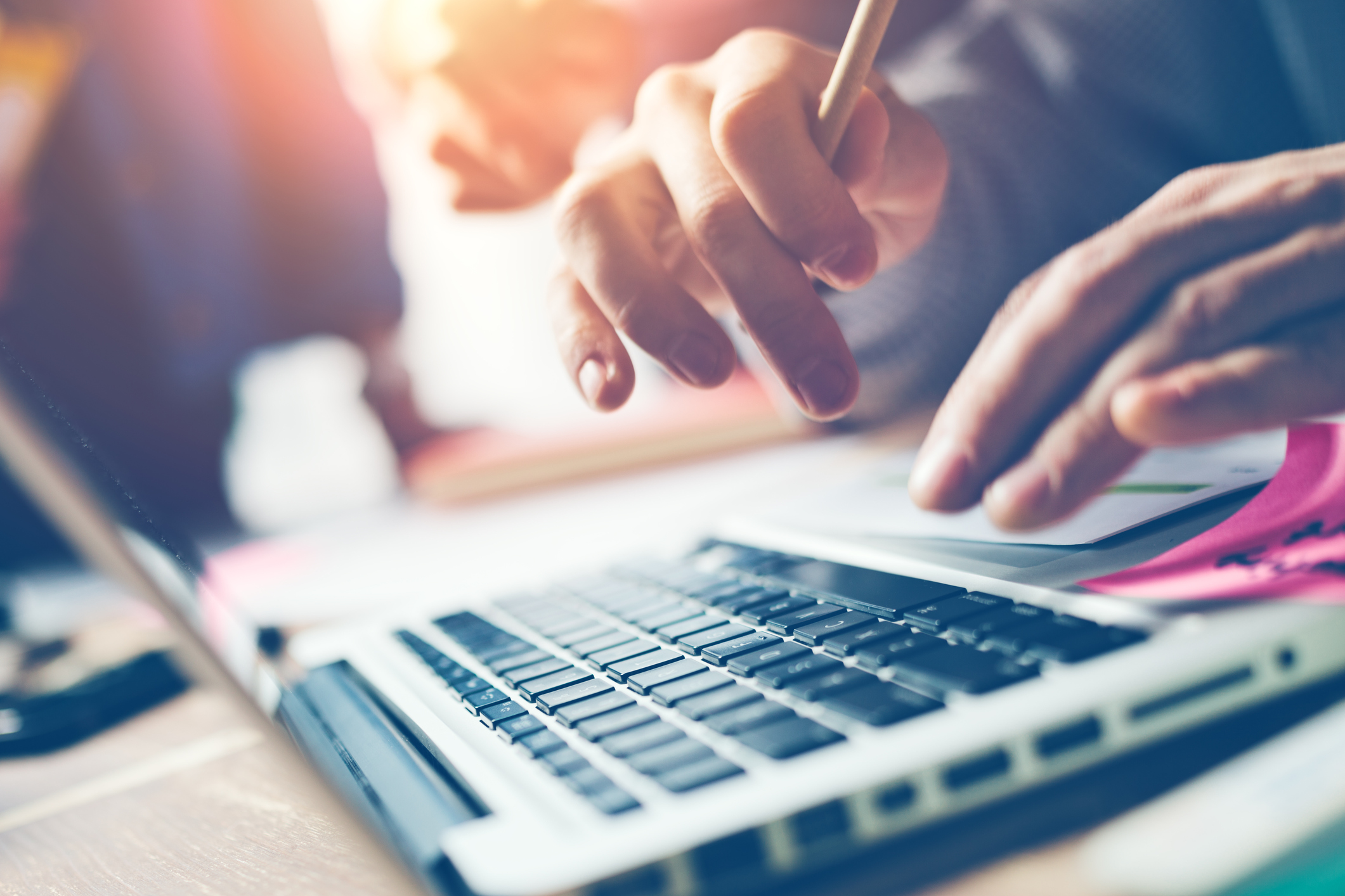 Image of person typing on laptop