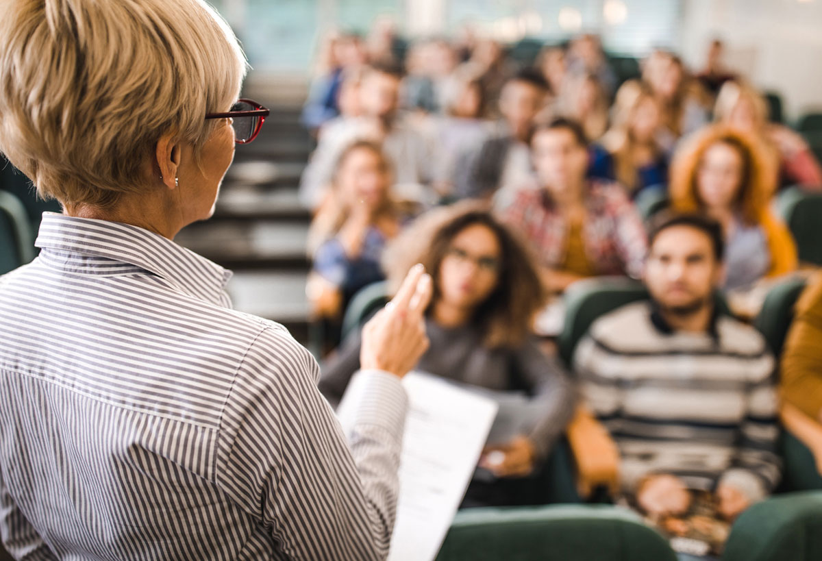 Woman presenting to a class.